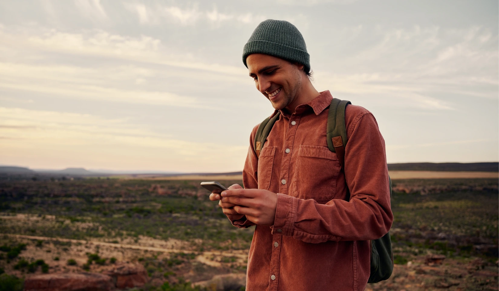 Person smiling at the phone while outdoors at their post goes viral