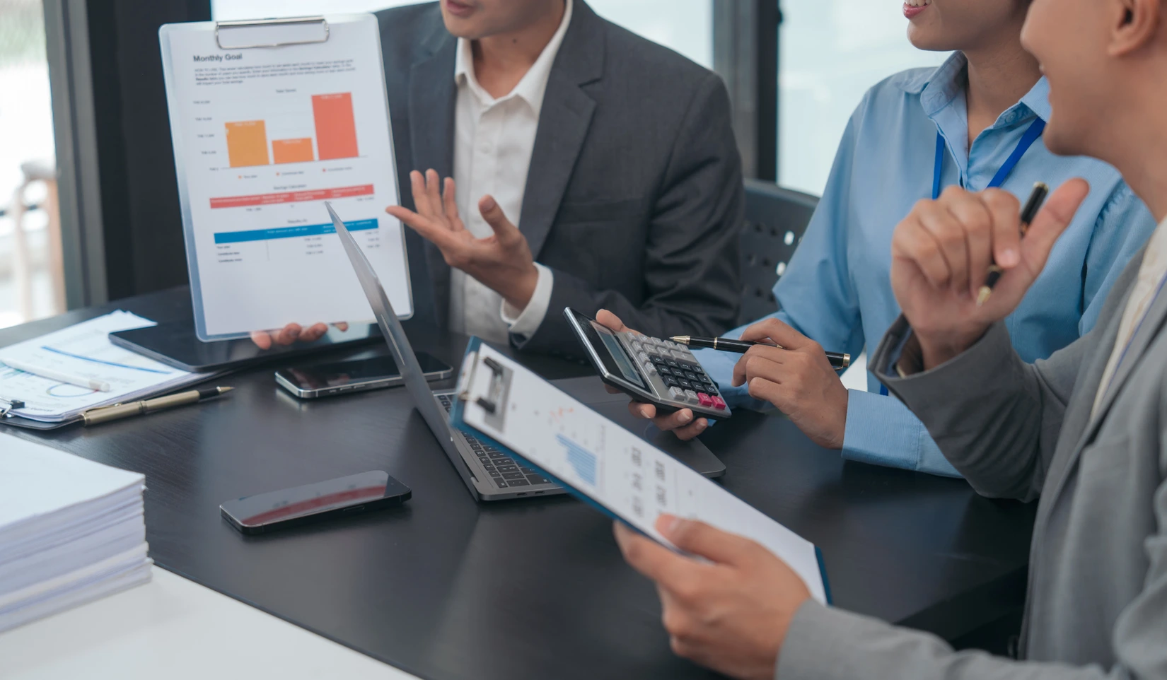 Marketing team collaborating around a table to plan a successful marketing strategy